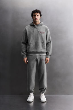 PRINTED TEXT JOGGING TROUSERS