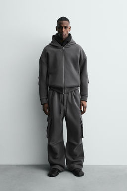 NEOPRENE-EFFECT PLEATED CARGO TROUSERS