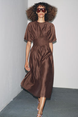 PLEATED WAIST KNIT DRESS WITH MATCHING DETAIL