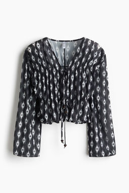Blusa de malla con lazadas