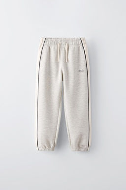 TROUSERS WITH CONTRAST PIPED STRIPES