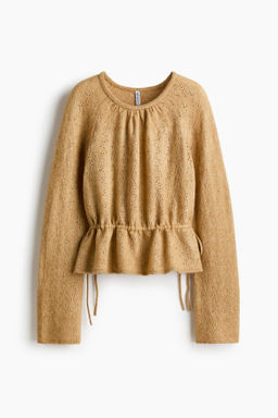 Top en punto pointelle con peplum